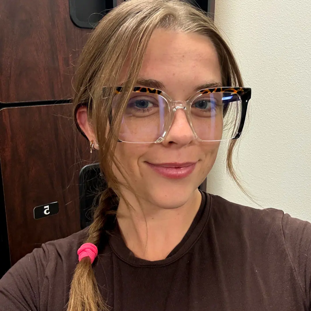 Close-up view of female wearing colorful black square eyeglasses, natural expression, SR0032502