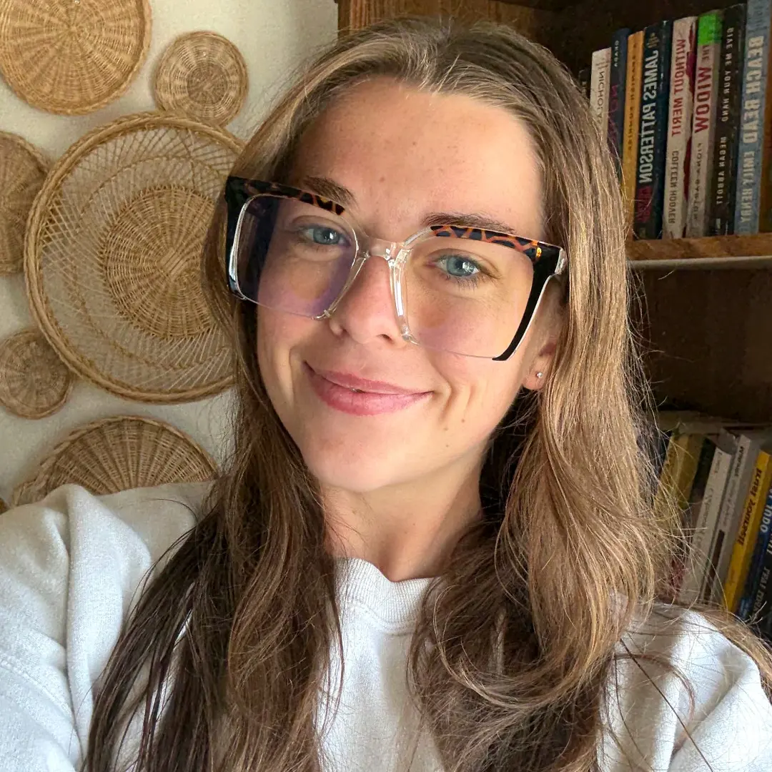 Three-quarter view of female wearing colorful black square eyeglasses, natural smile, SR0032502