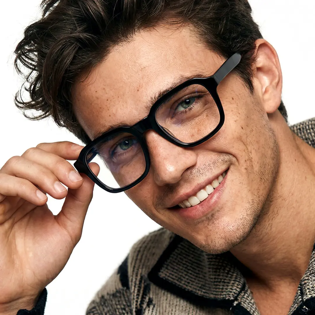 Tilted head view of male wearing black square eyeglasses, touching frame, smiling, SR0032508