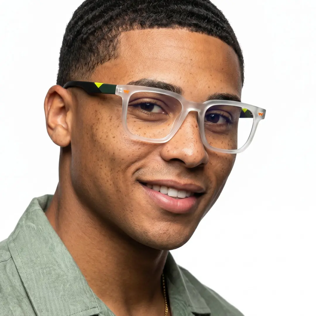 Profile view of male wearing clear square eyeglasses, smiling, SR0032604