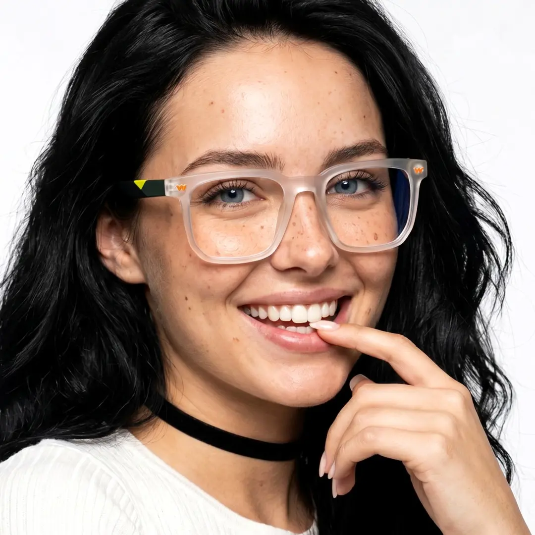 Three-quarter view of female wearing clear square eyeglasses, hand touching lips, smiling, SR0032604