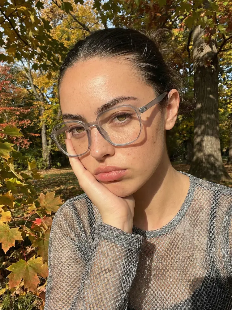 Female model wearing vintage grey square tr90 eyeglasses in an autumn park with sunlight and colorful leaves. SPU: SR0052410
