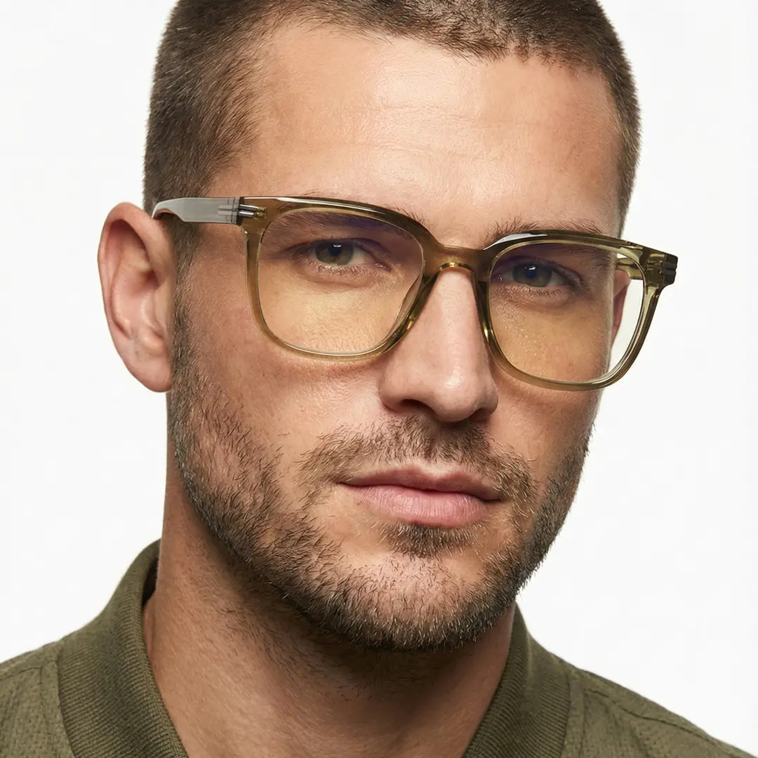 Tilted head view of male wearing green square eyeglasses, calm expression, SR0052508