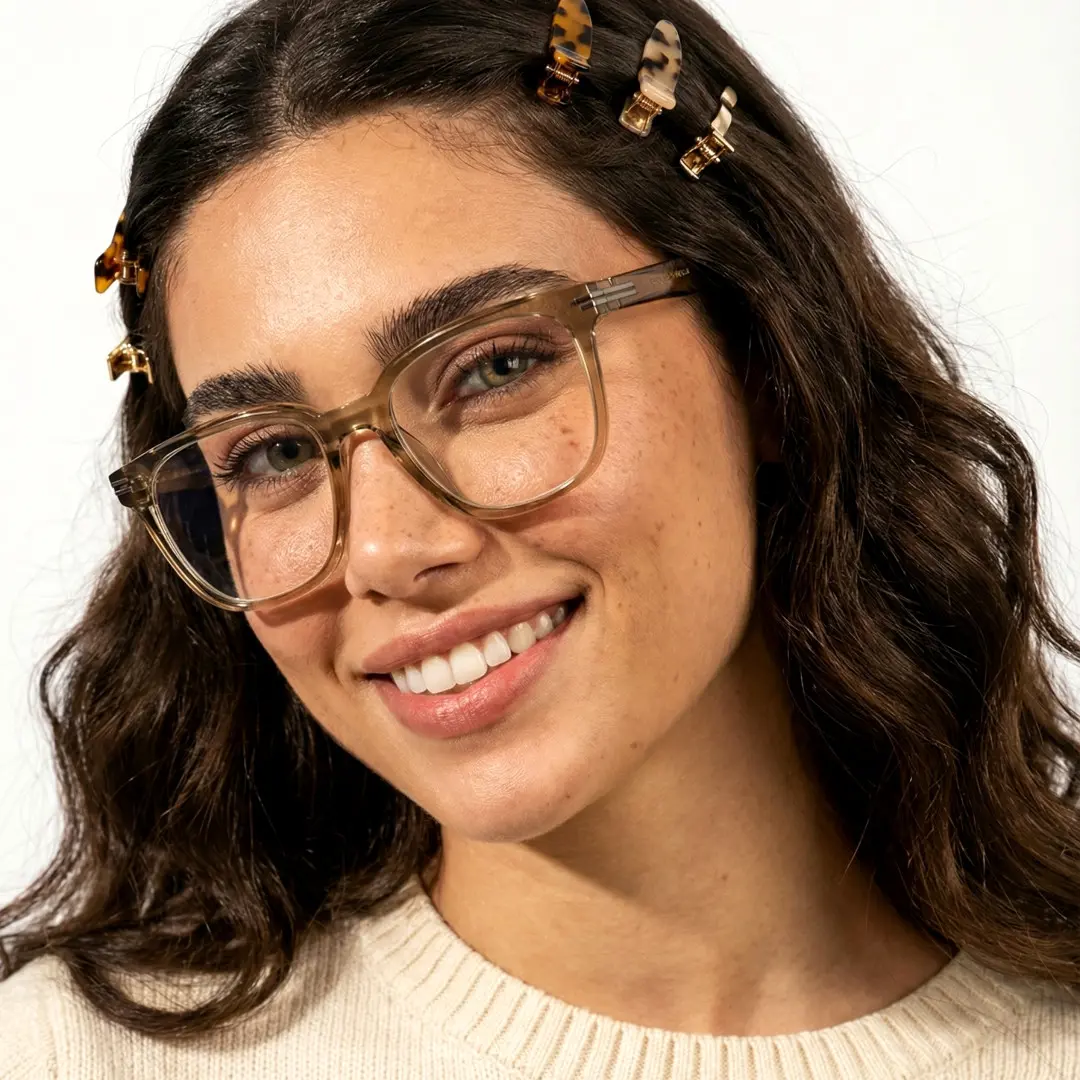 Three-quarter view of female wearing green square eyeglasses, smiling, SR0052508