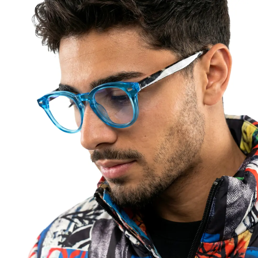 Looking away view of male wearing blue square eyeglasses, thoughtful expression, SR0062507