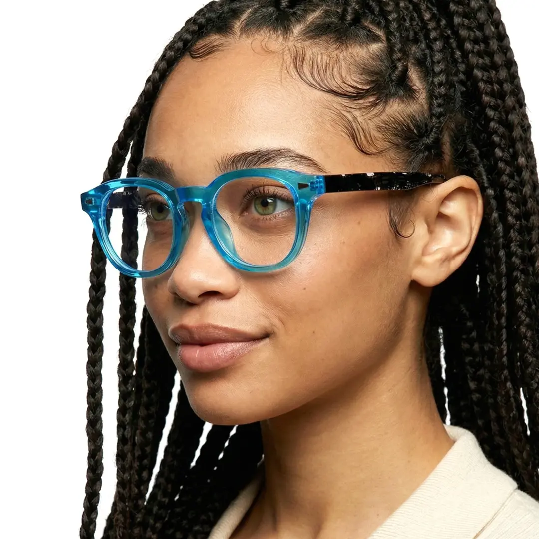 Looking away view of female wearing blue square eyeglasses, natural smile, SR0062507