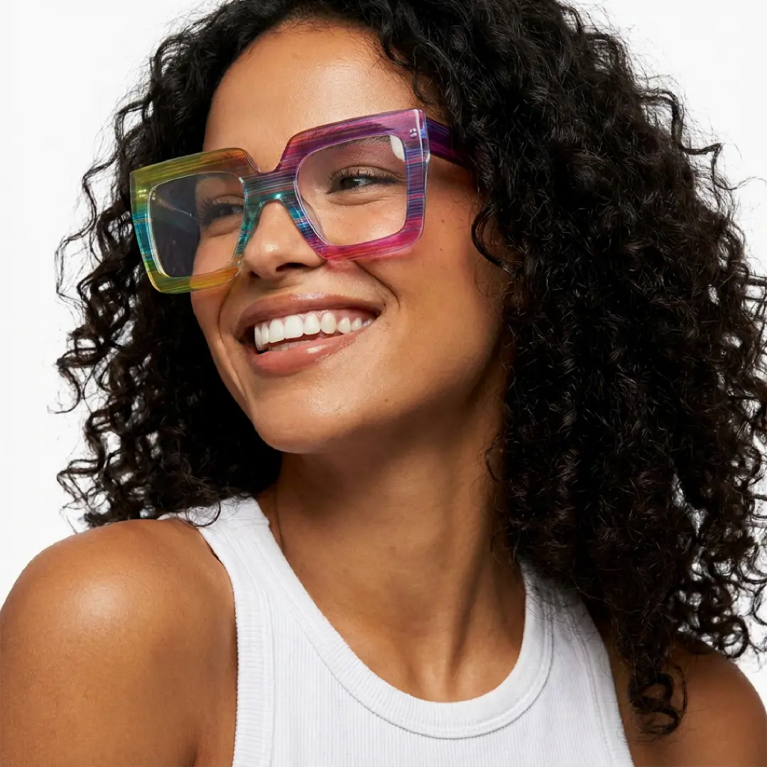 Looking away view of female wearing multicolor square eyeglasses, natural smile, SR0062509