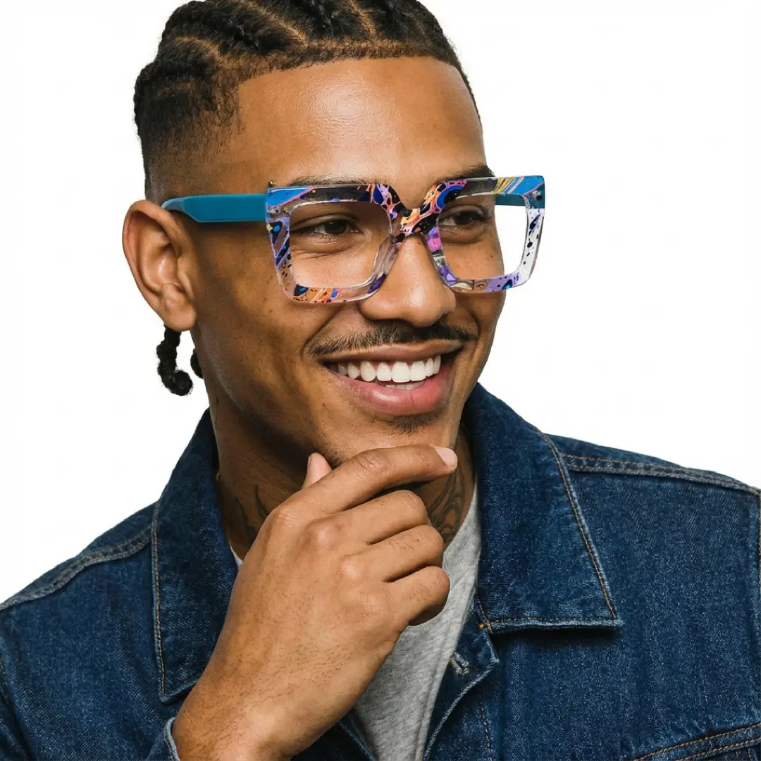 Looking away view of male wearing multicolor square eyeglasses, resting chin on hand, friendly smile, SR0082509