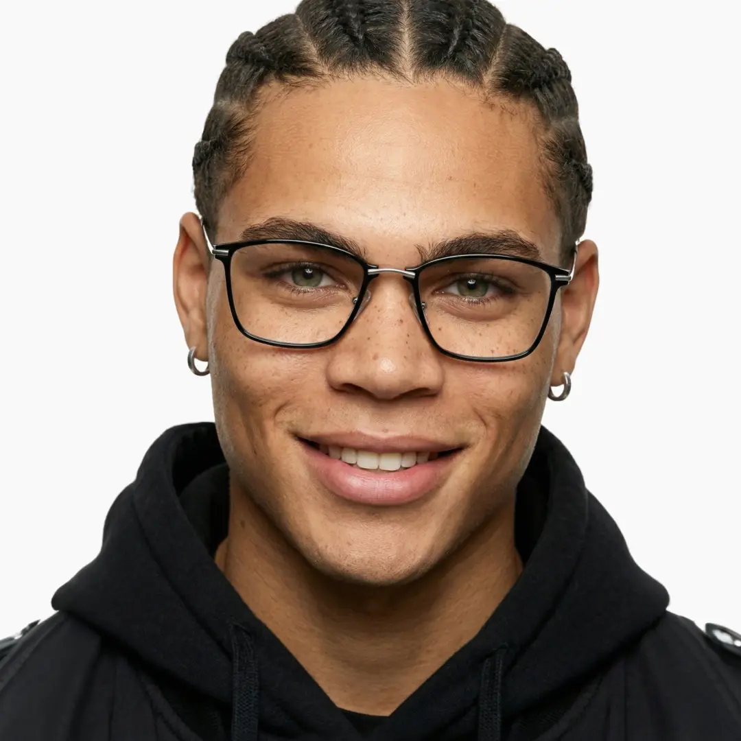 Front view of male wearing black square eyeglasses, smiling, SR0092409