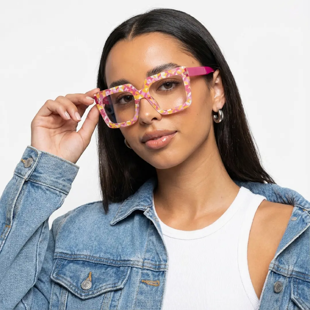 Looking straight ahead view of female wearing two tone square eyeglasses, holding glasses, natural expression, SR0092509