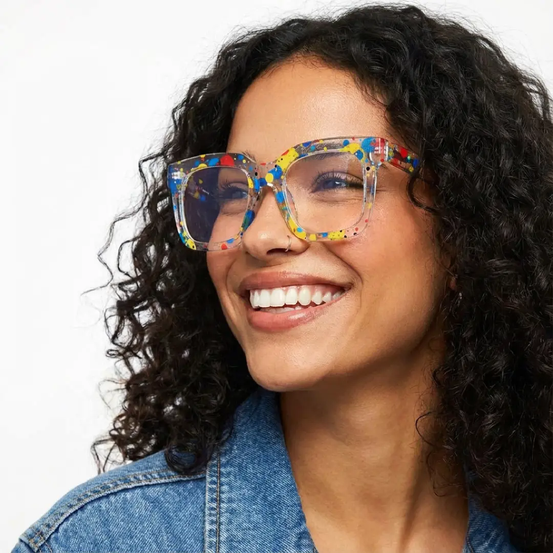 Three-quarter view of female wearing multicolor square eyeglasses, wide smile, SR0112509