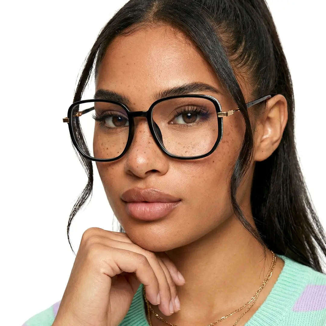 Front view of female wearing vintage black square eyeglasses, resting chin on hand, natural expression, SR0162409