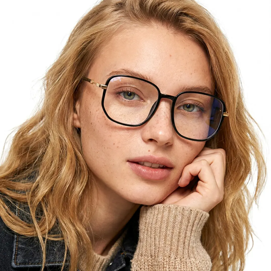 Front view of female wearing vintage black square eyeglasses, resting chin on hand, relaxed expression, SR0162409