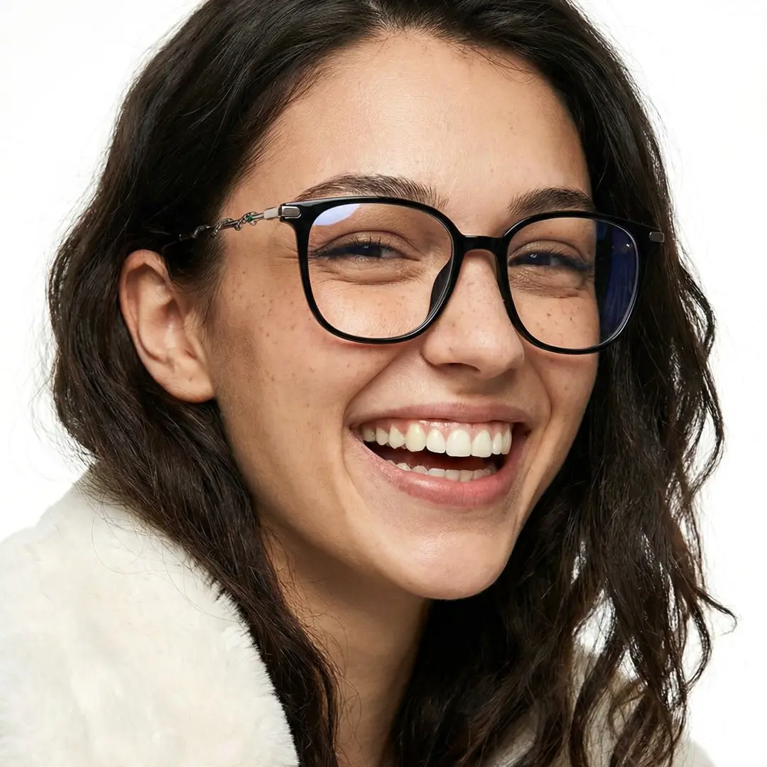 Three-quarter view of female wearing black square eyeglasses, smiling, SR0162601