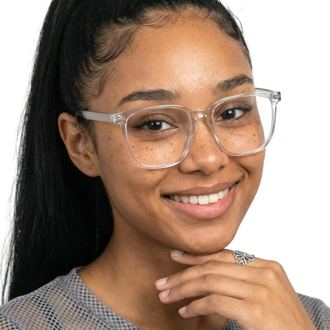 Three-quarter view of female wearing grey square eyeglasses, hand touching chin, smiling, SR0172409