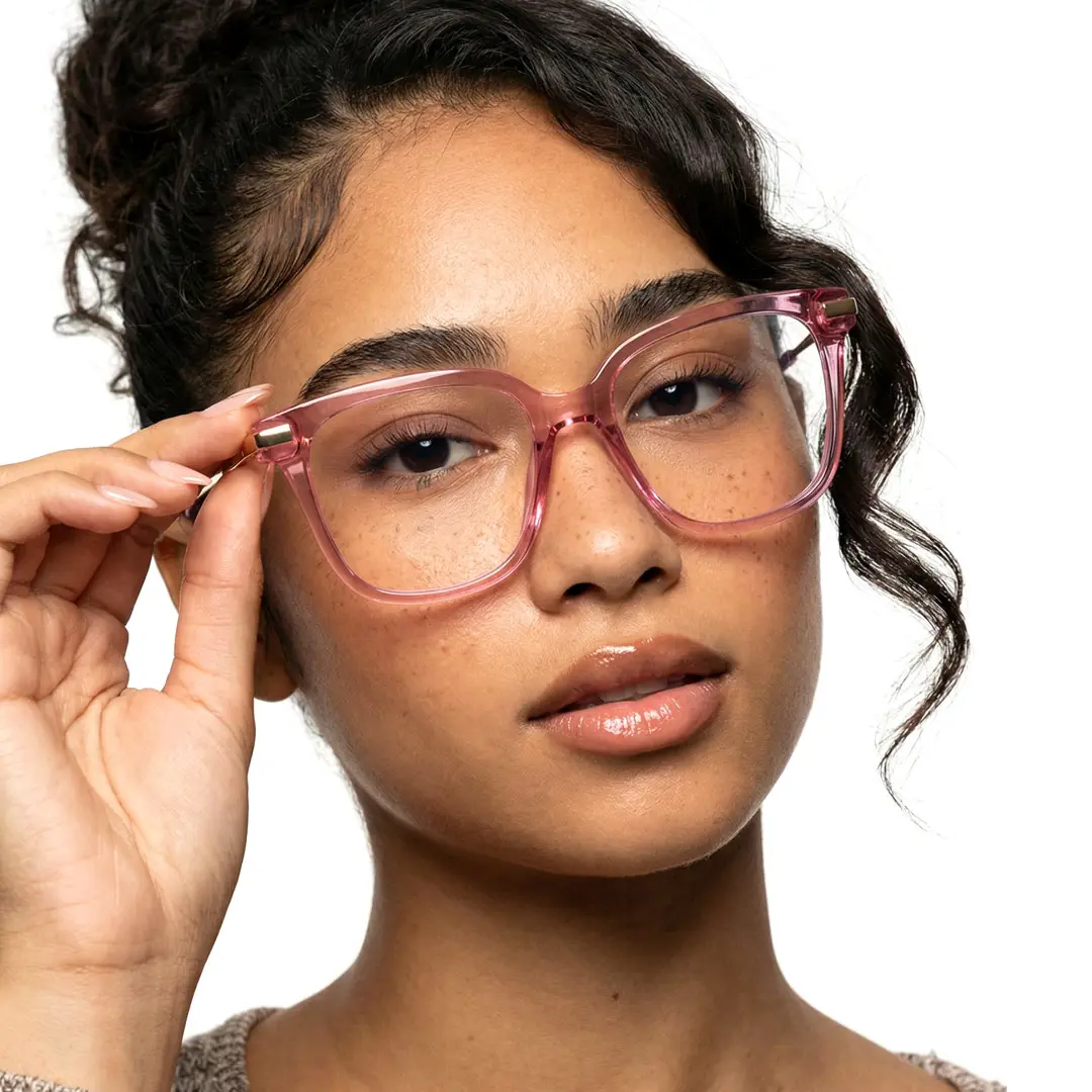 Front view of female wearing pink square eyeglasses, holding glasses, natural expression, SR0192502