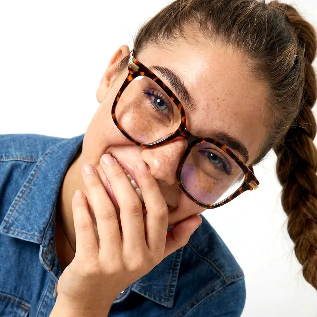 Front view of female wearing tortoise square eyeglasses, natural smile, SR0192502