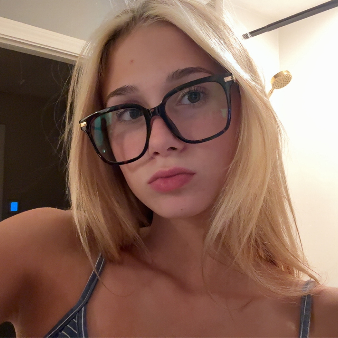 Front view of female wearing tortoise square eyeglasses, relaxed expression, SR0192502