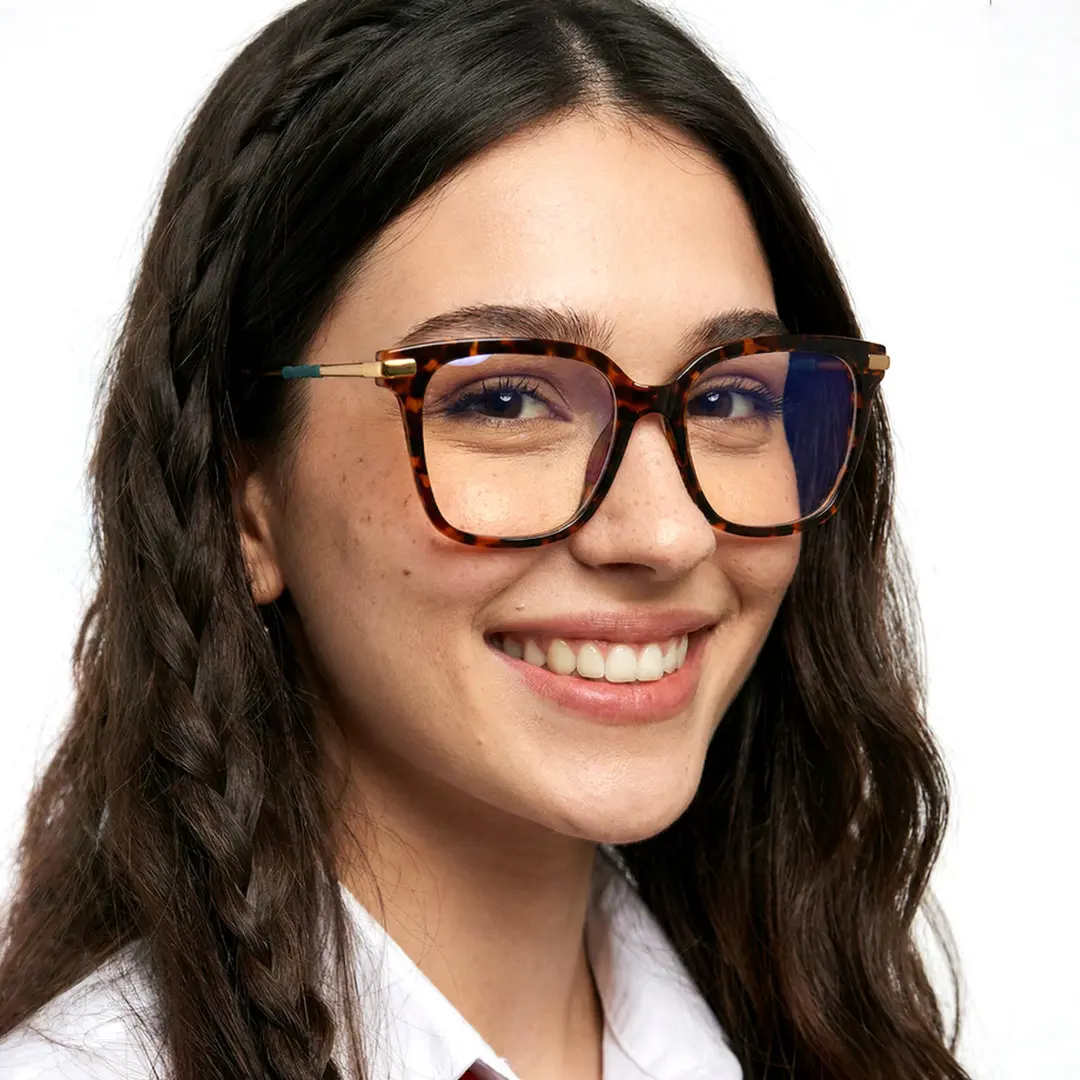 Three-quarter view of female wearing tortoise square eyeglasses, smiling, SR0192502