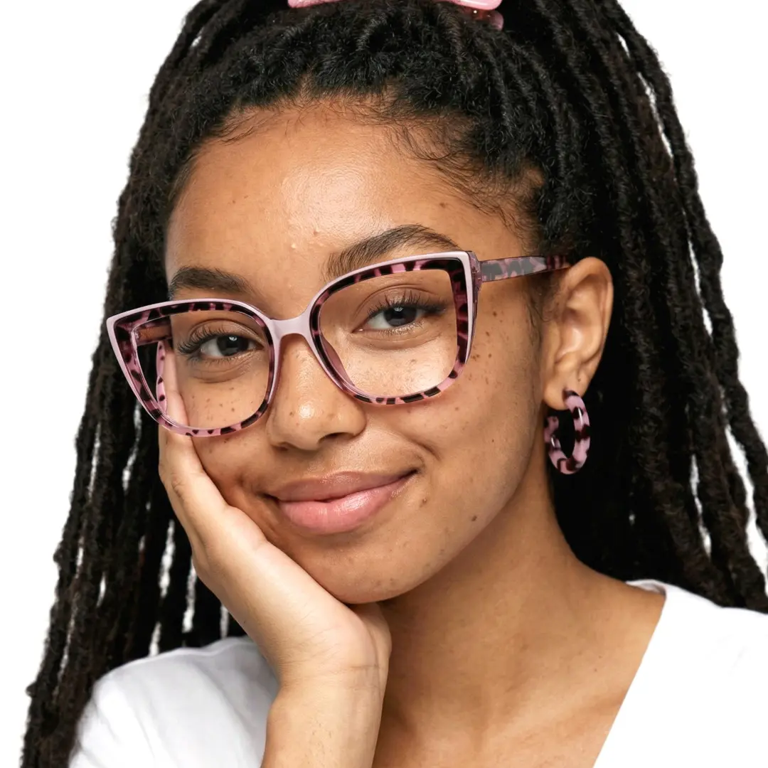 Front view of female wearing red tortoise square eyeglasses, resting chin on hand, natural smile, SR0202411