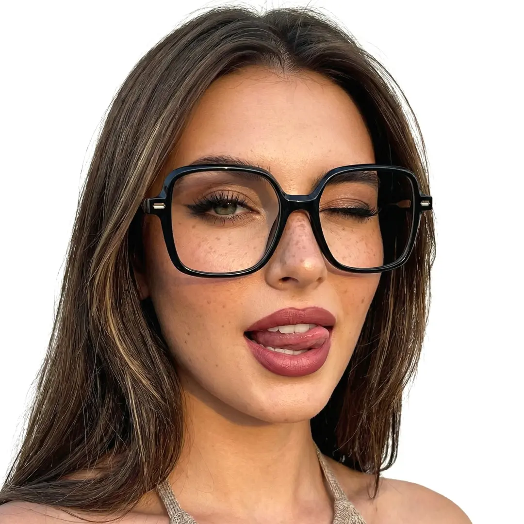Slightly angled view of female wearing vintage black square eyeglasses, sticking out tongue, confident expression, SR0362508