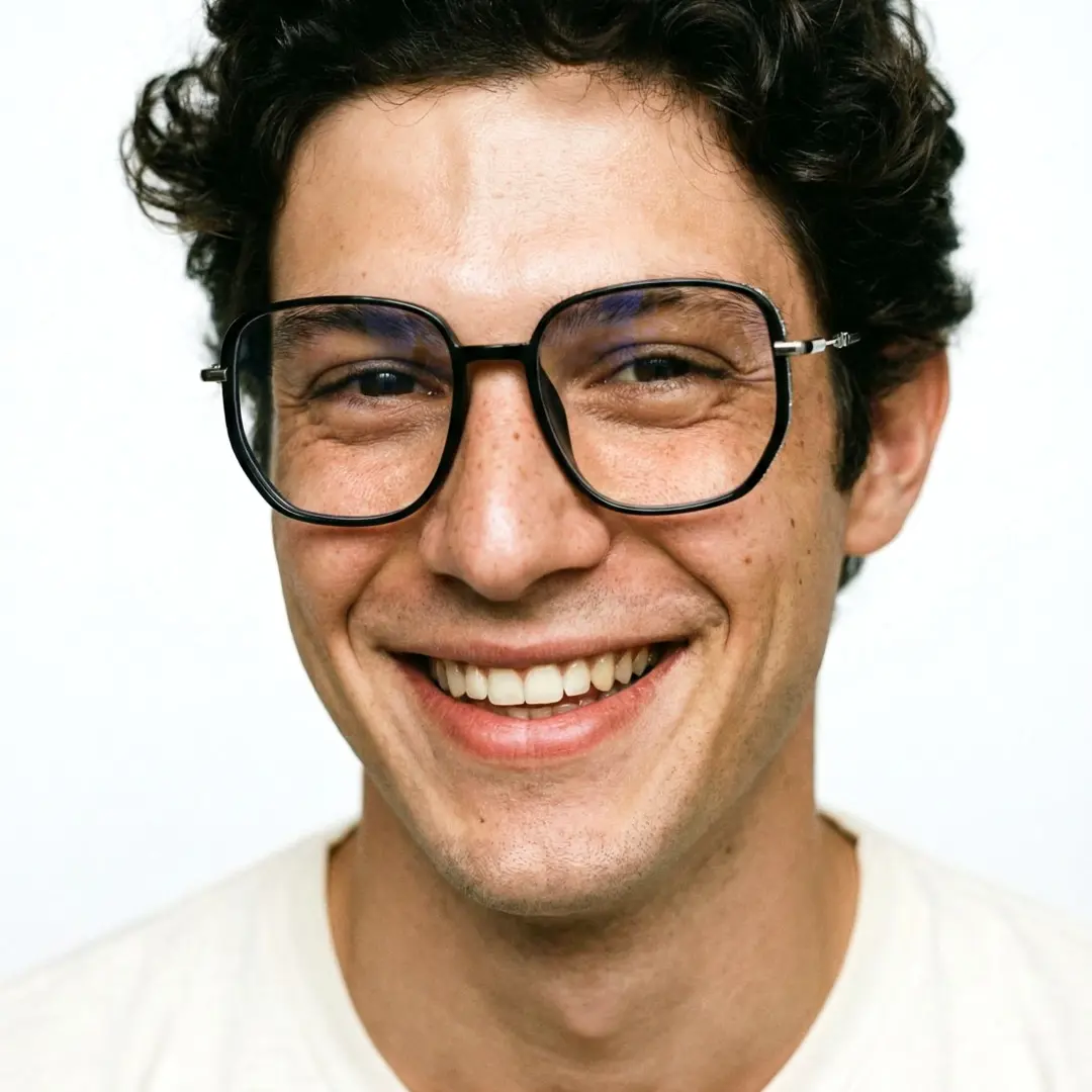 Front view of male wearing black square eyeglasses, smiling, SR0992509