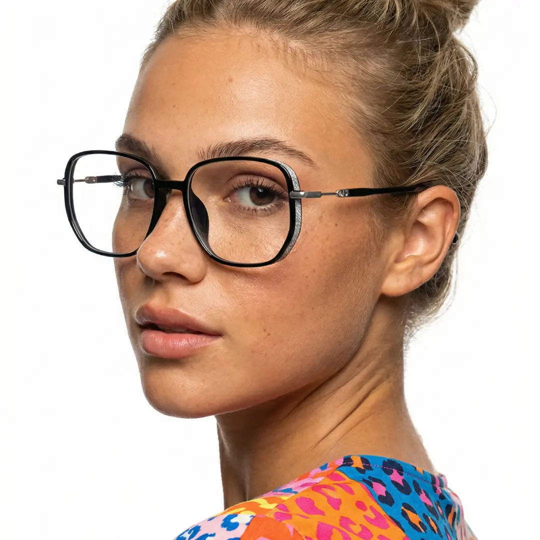 Over-the-shoulder view of female wearing vintage black square eyeglasses, natural expression, SR0992509