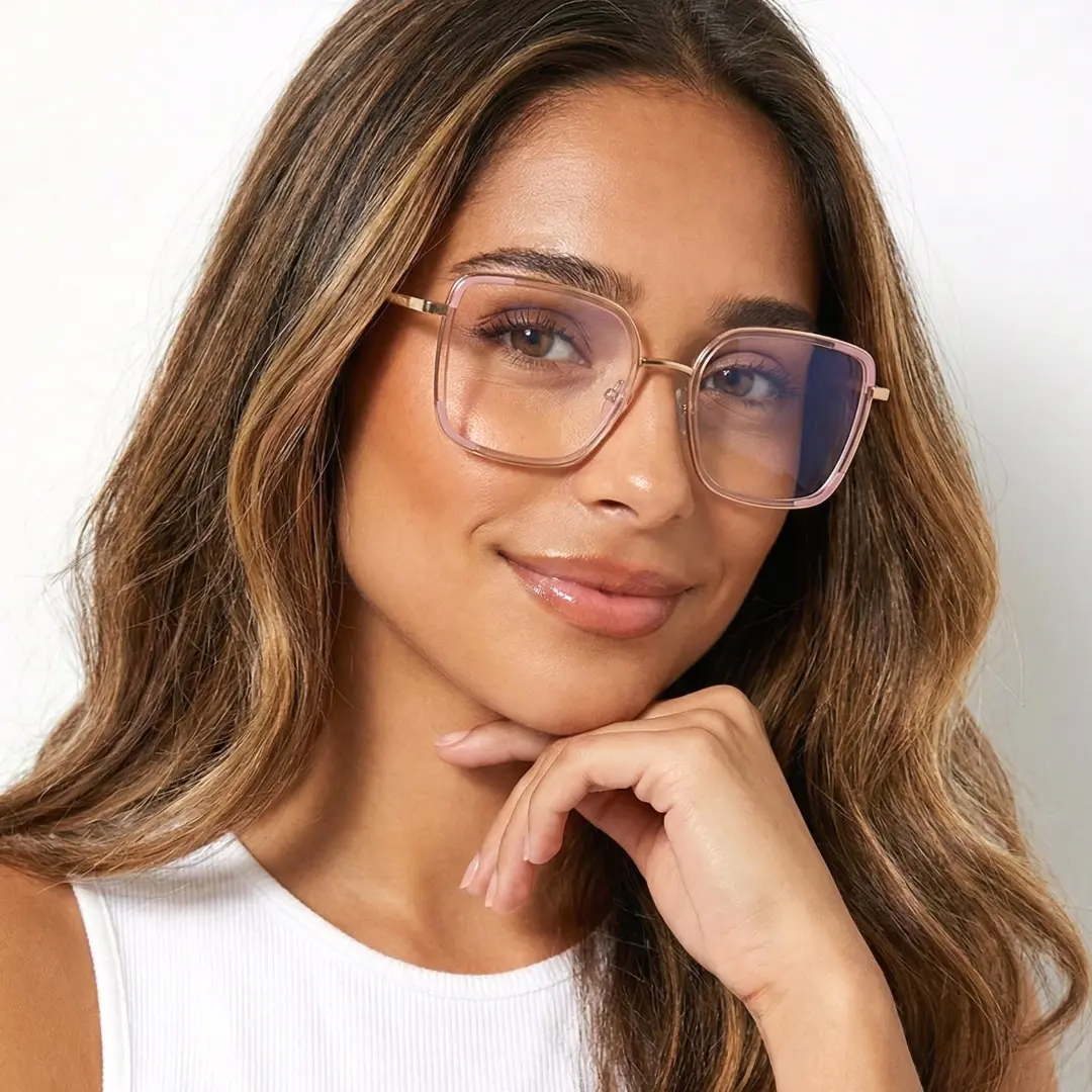 Front view of female wearing pink square eyeglasses, resting chin on hand, soft smile, SX0302508