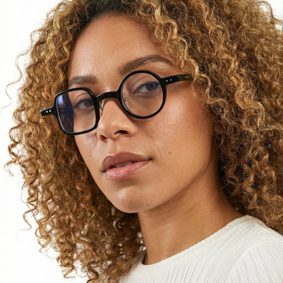 Three-quarter view of female wearing vintage black unique eyeglasses, relaxed expression, UA0042001