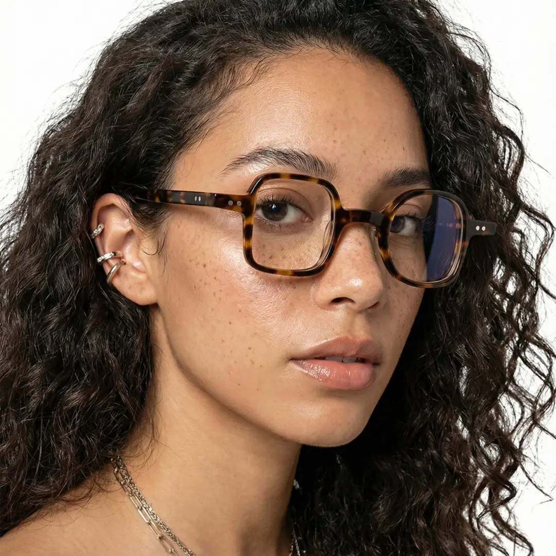 Three-quarter view of female wearing tortoise unique eyeglasses, neutral expression, UA0042001
