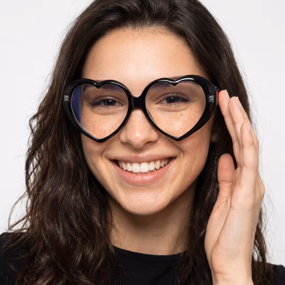 Front view of female wearing y2k black unique eyeglasses, touching frame, smiling, UP0232604