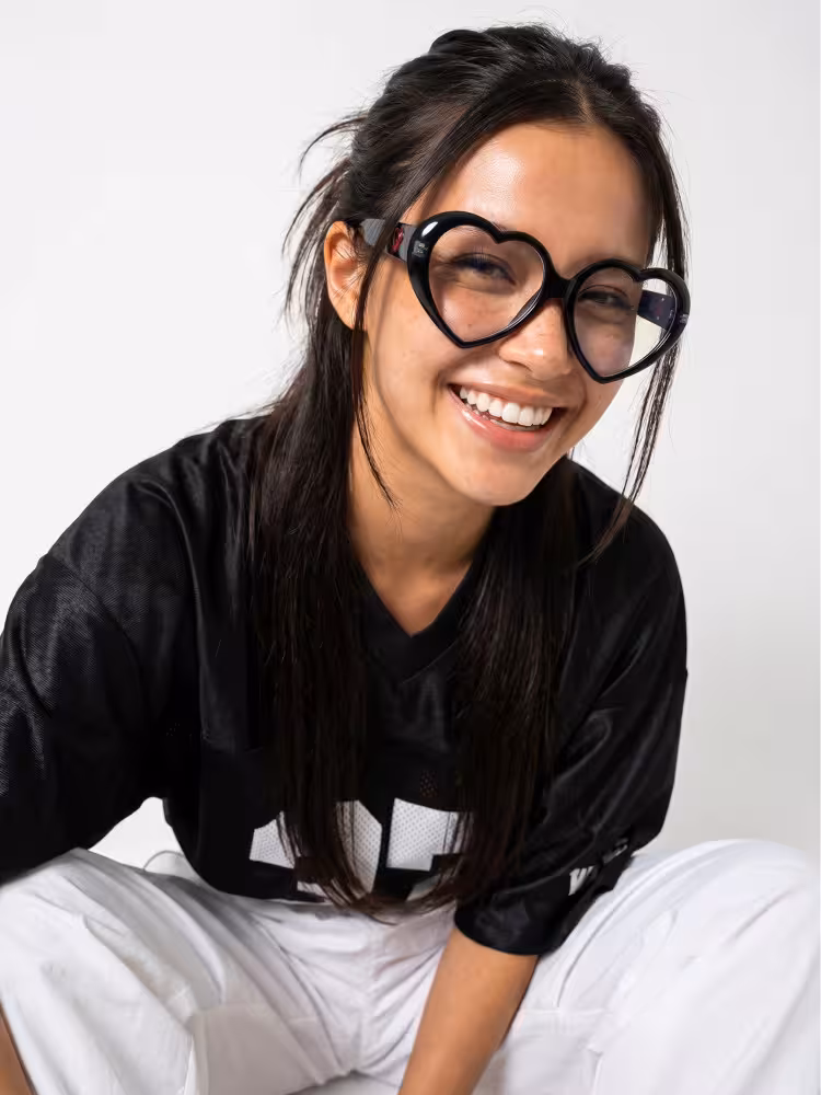 Female model wearing y2k black unique heart-shaped pc eyeglasses in a minimalist studio setting. SPU: UP0232604