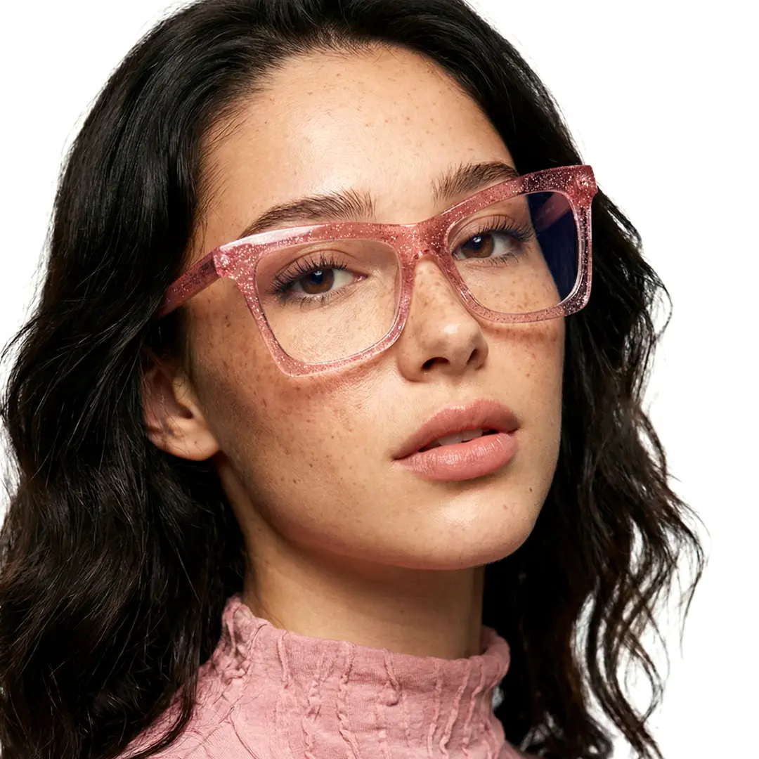 Tilted head view of female wearing pink butterfly eyeglasses, natural expression, UR0152502