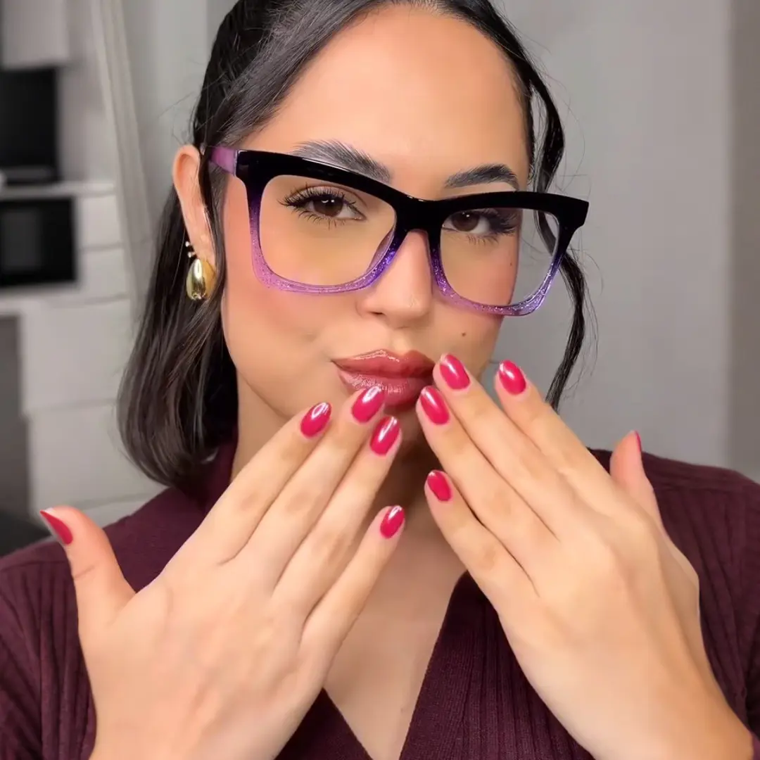 Straight-on view of female wearing purple butterfly eyeglasses, pouting, relaxed expression, UR0152502