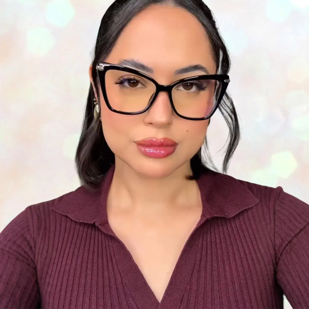 Front view of female wearing black butterfly eyeglasses, pouting, natural expression, UR0172502