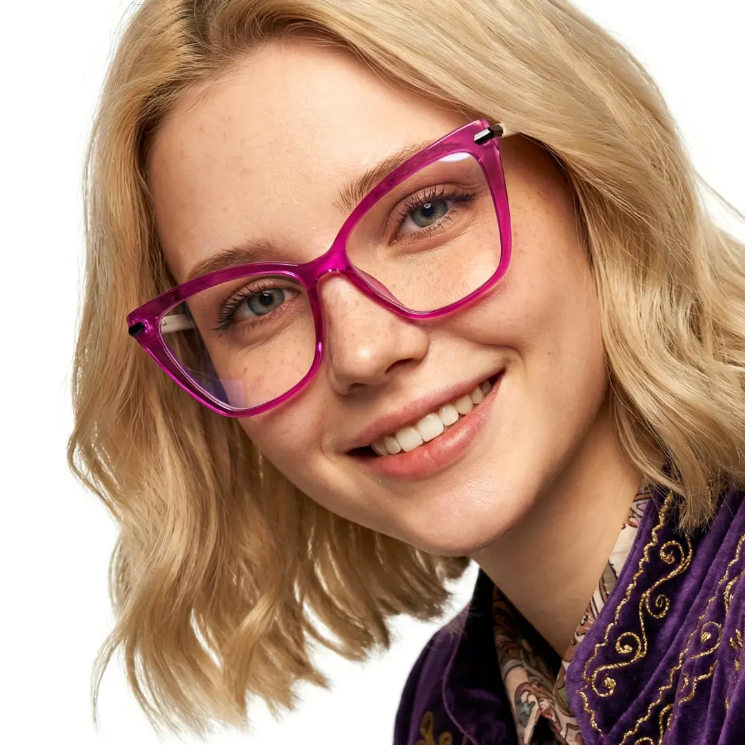 Tilted head view of female wearing purple butterfly eyeglasses, soft smile, UR0172502