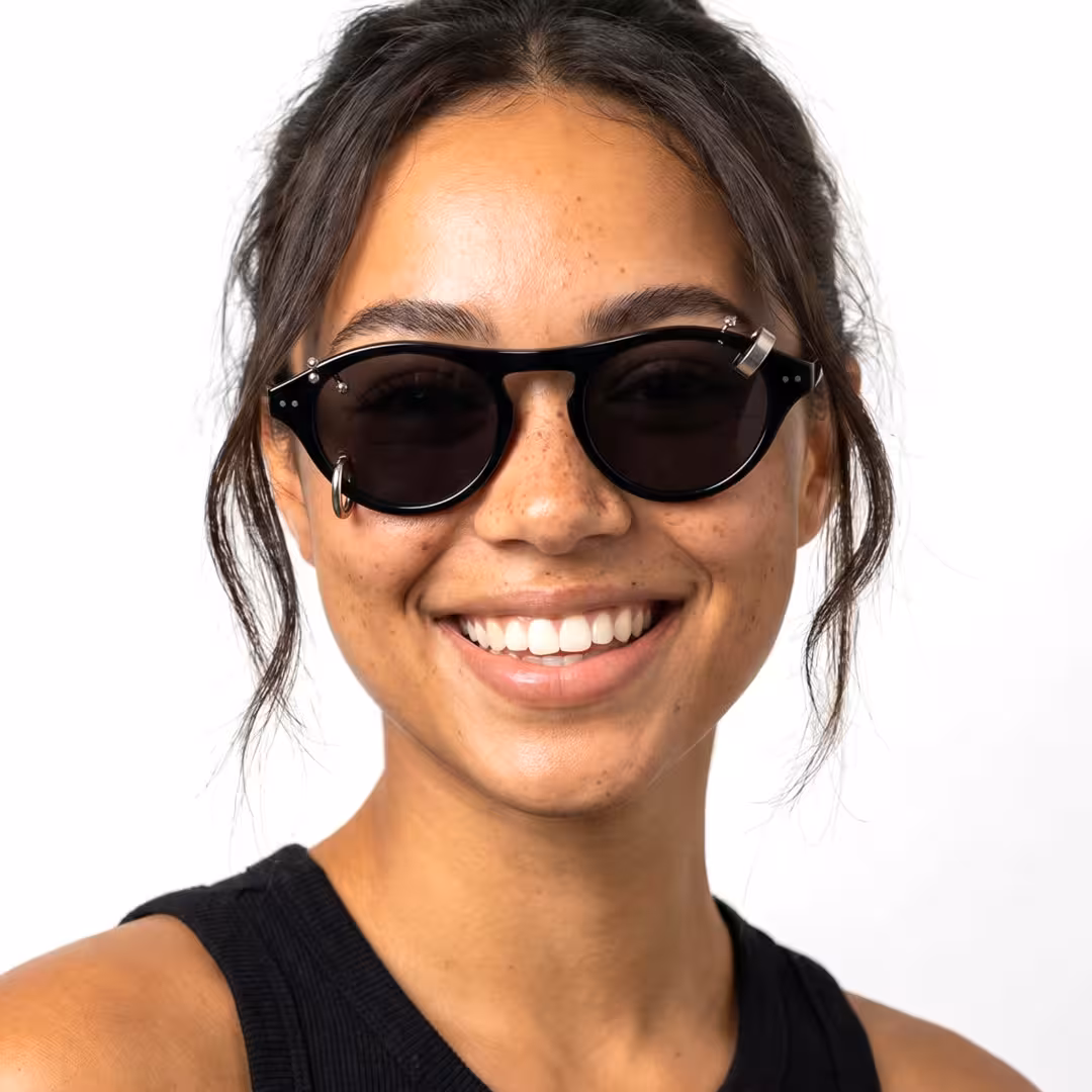 Close-up view of female wearing silver aviator handcrafted polarized sunglasses, smiling, AA0062604