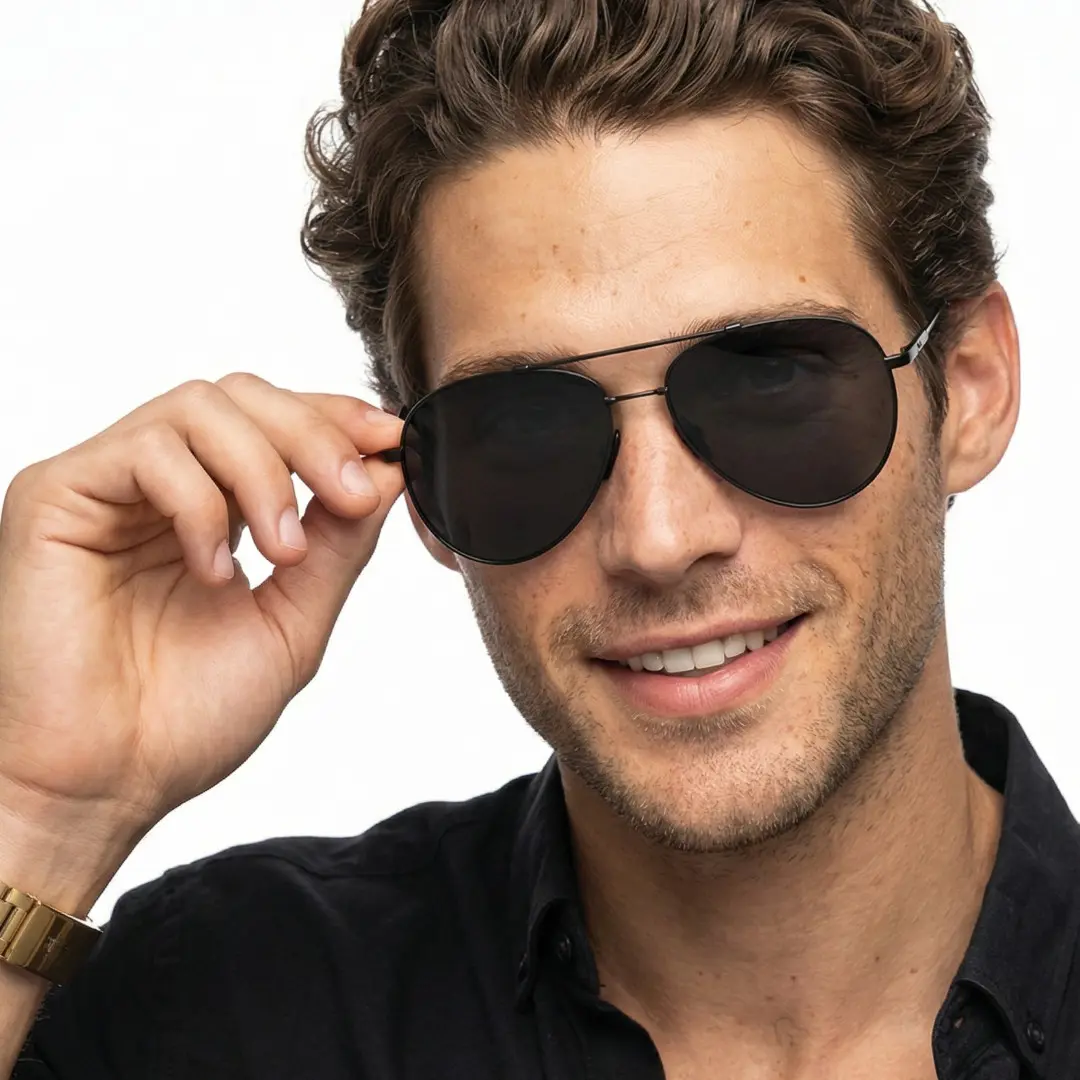 Front view of male wearing vintage black aviator sunglasses, holding glasses, friendly smile, AM0042603