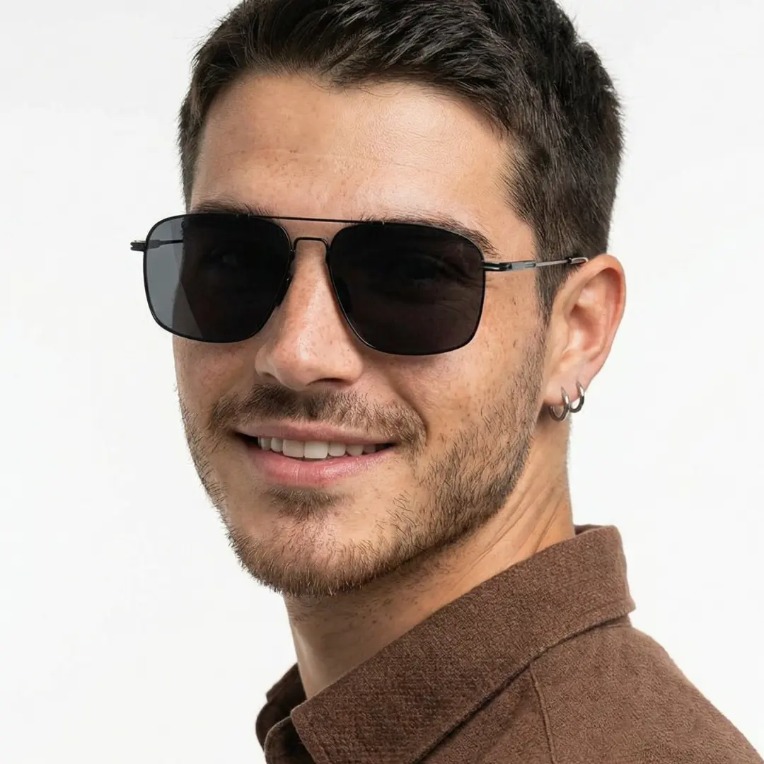 Over-the-shoulder view of male wearing vintage black aviator sunglasses, natural smile, AM0052603