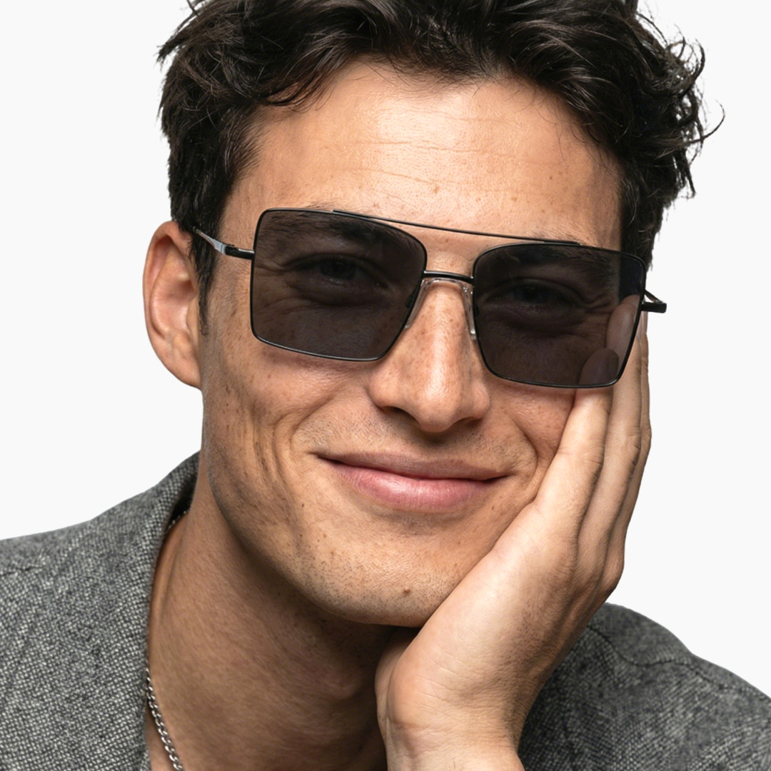Front view of male wearing fashion grey aviator sunglasses, hand near face, friendly smile, AM0072505