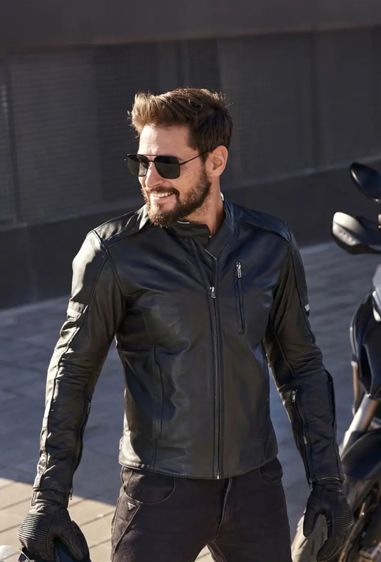 Male model wearing fashion grey aviator metal sunglasses on an urban street next to a motorcycle. SPU: AM0072505