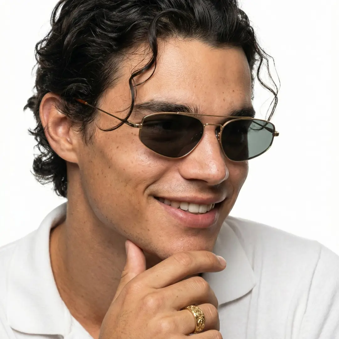 Face close-up view of male wearing gold aviator sunglasses, resting chin on hand, natural smile, AM0082603