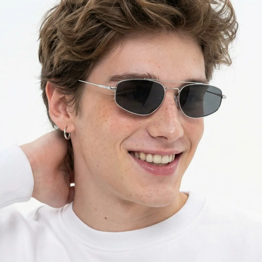 Looking away view of male wearing silver aviator sunglasses, natural smile, AM0082603