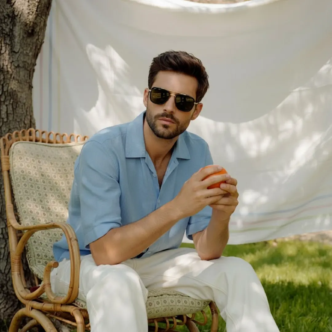 Three-quarter view of male wearing fashion gold aviator sunglasses, calm expression, AM0182409