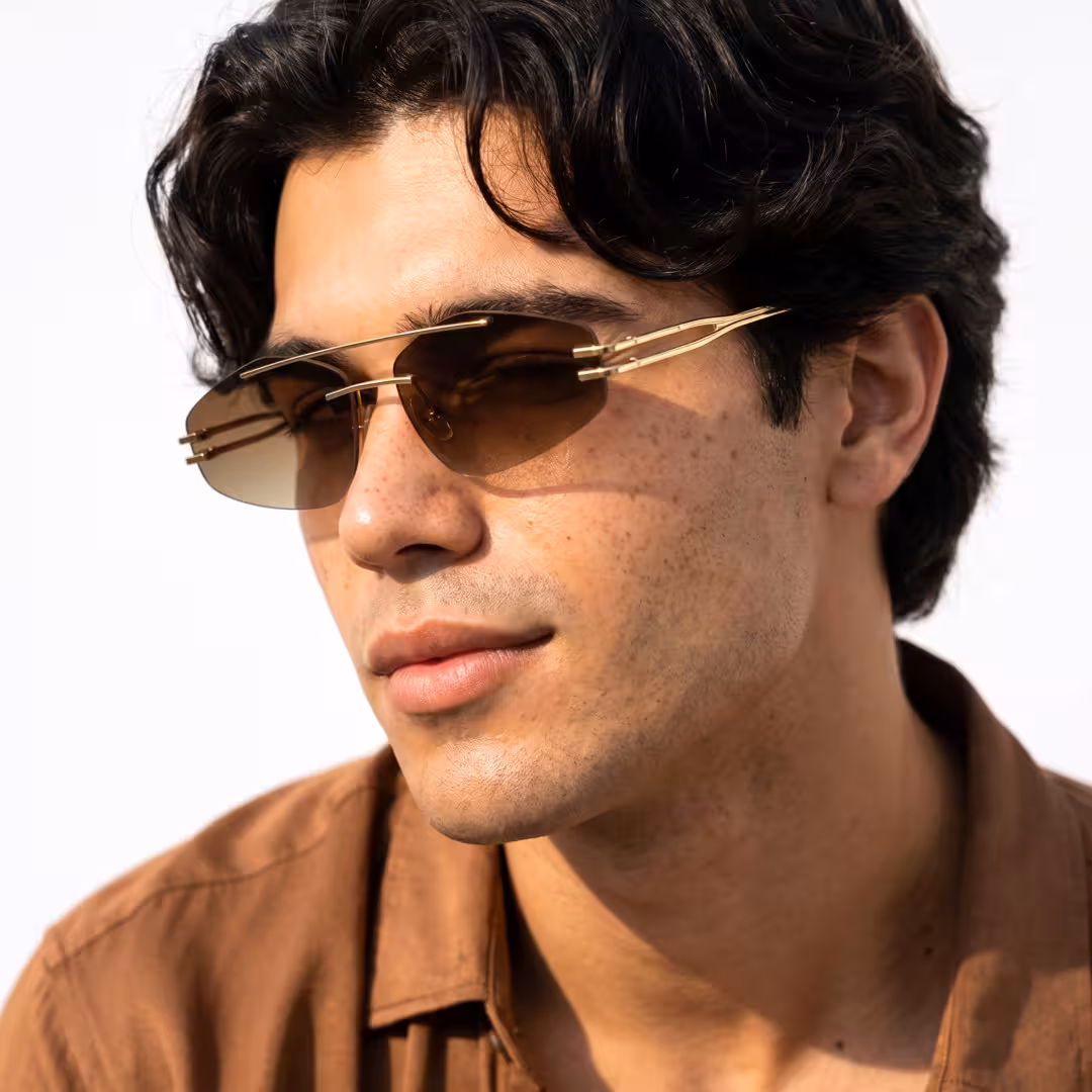 Profile view of male wearing fashion gold aviator sunglasses, neutral expression, AM0202604