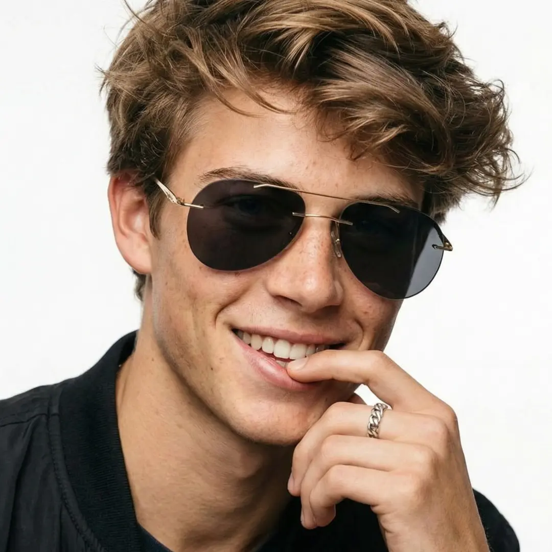 Profile view of male wearing gold aviator sunglasses, hand near face, smiling, AM0492506S