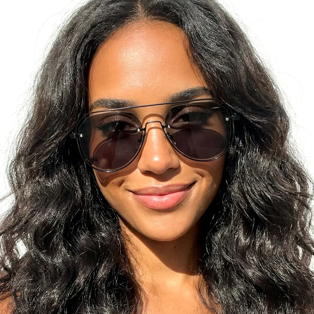 Front view of female wearing vintage grey aviator sunglasses, soft smile, AP0022505