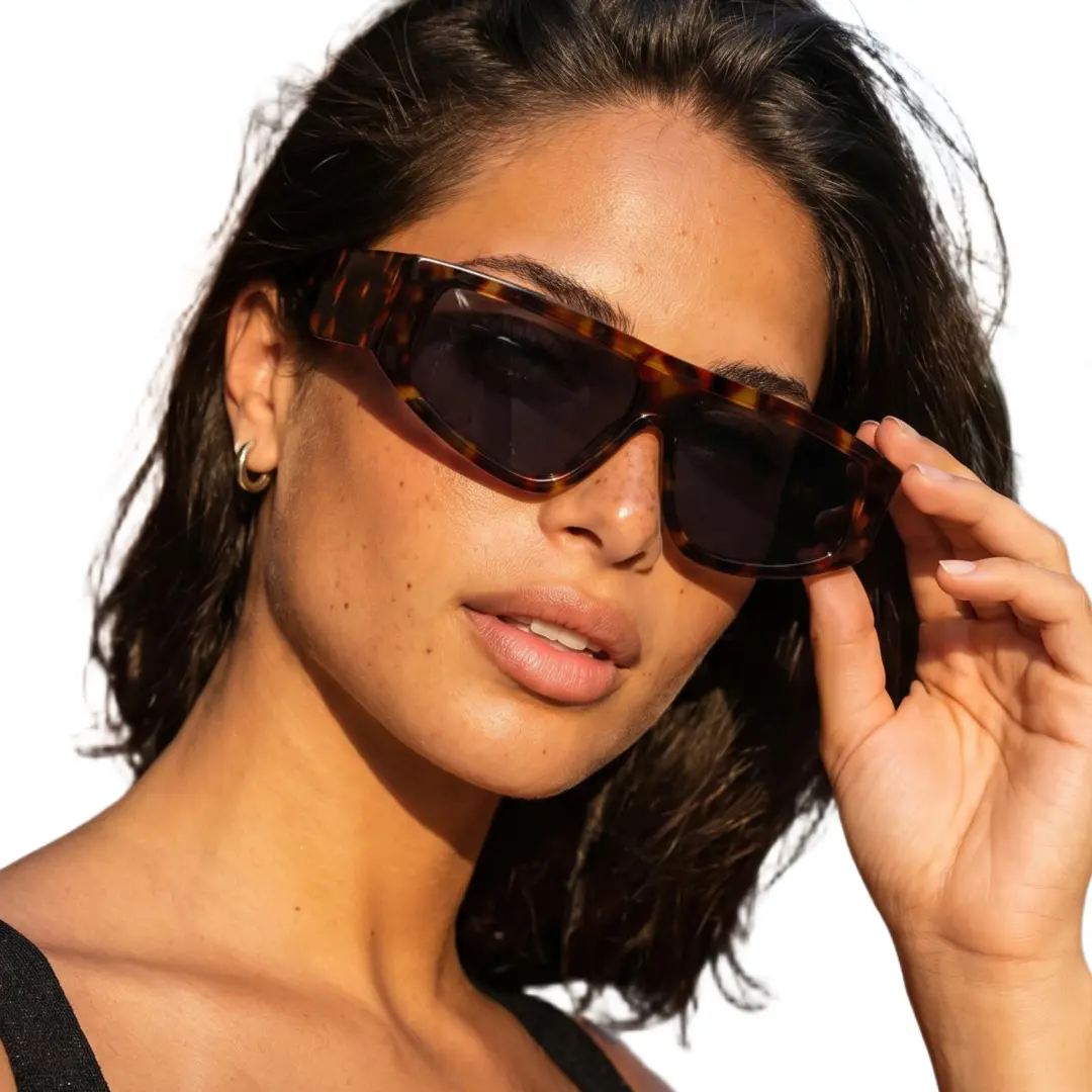 Close-up view of female wearing fashion vintage tortoise aviator sunglasses, touching frame, natural expression, AP0092604