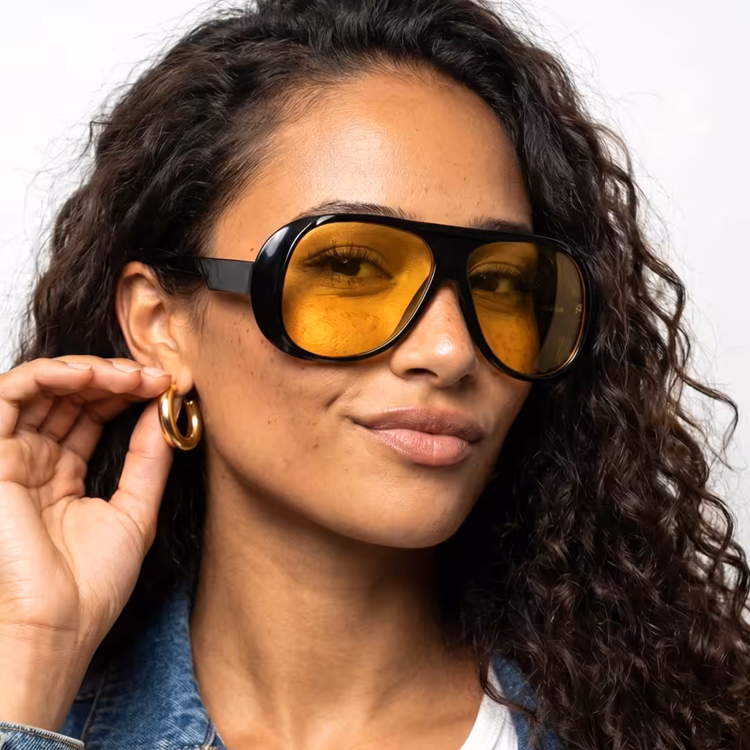 Profile view of female wearing vintage black aviator sunglasses, natural smile, AP0172604