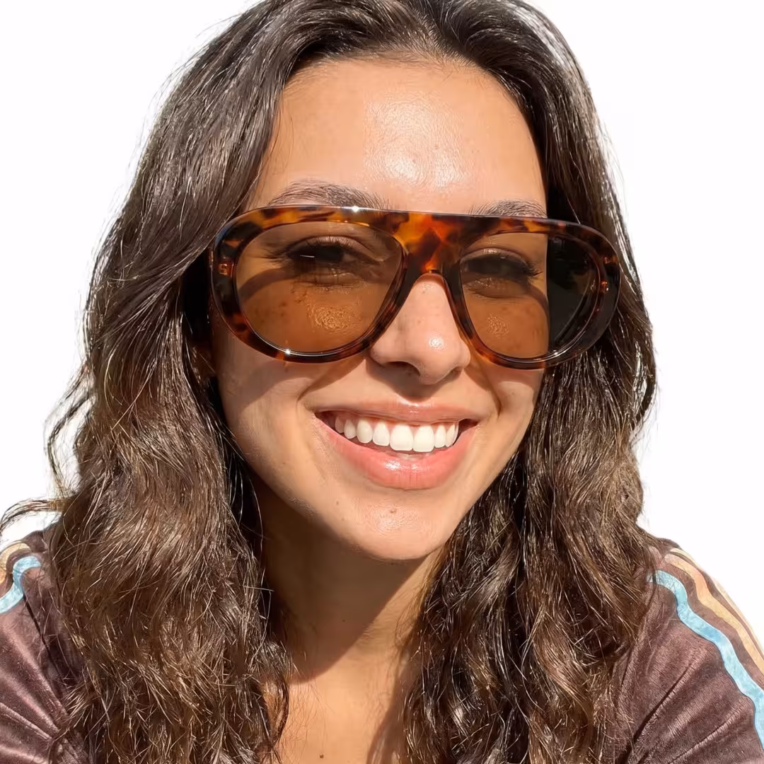 Three-quarter view of female wearing vintage tortosie aviator sunglasses, smiling, AP0172604